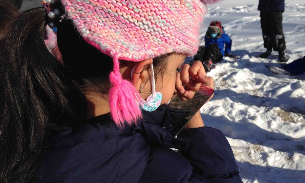 Student studying their own teeth in the mirror