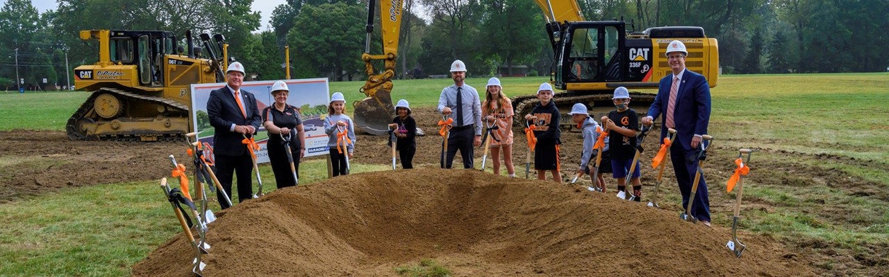 groundbreaking ceremony with people, kids and shovels