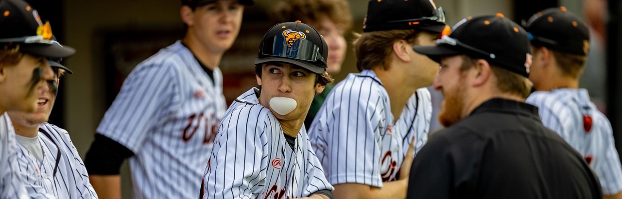 high school baseball players with one blowing a bubble