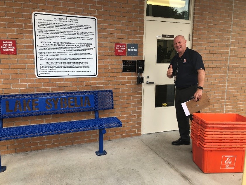 staff with recycling bins