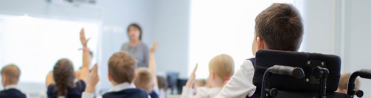 Student in a wheelchair sitting in a classroom.