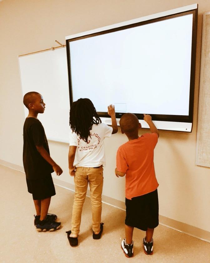 Mollie Ray Students play with smart board