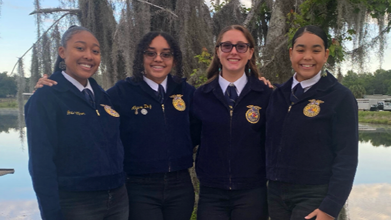 Four students smile for photo