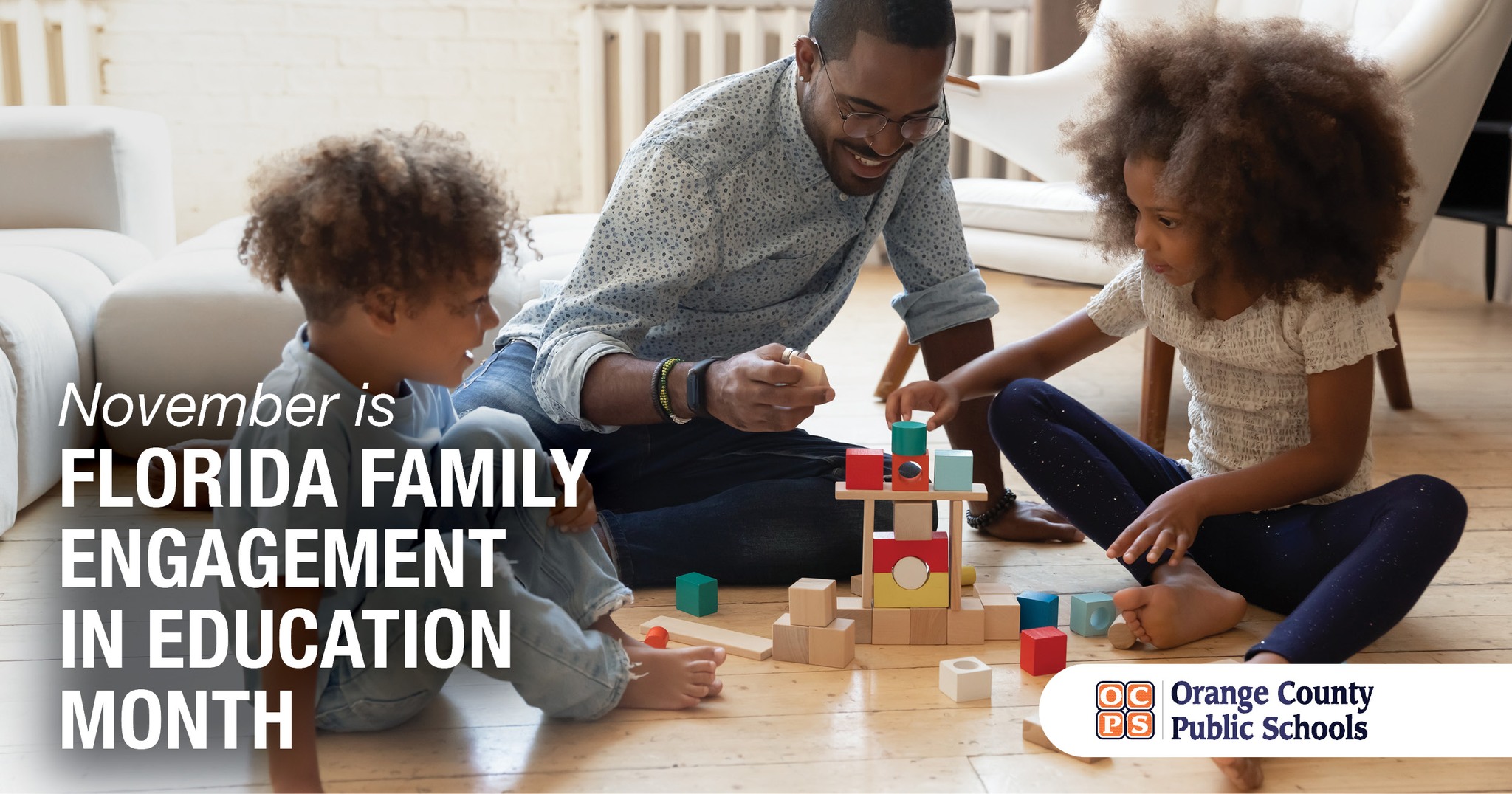 A man and two children play with blocks