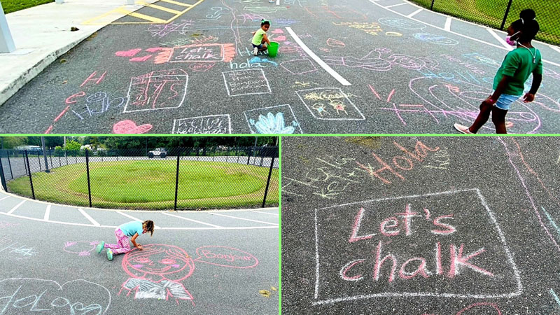 Students chalk positive messages on school entrance