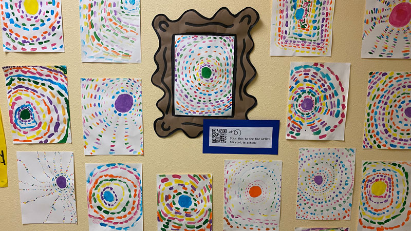 student artwork like Alma Thomas' taped to a wall