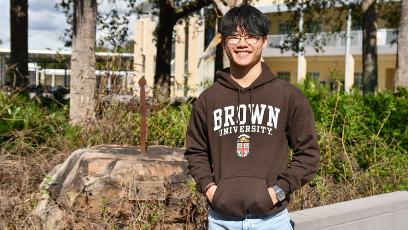 a male student wears a Brown University sweatshirt