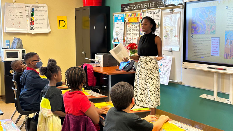 A female teacher gives instruction