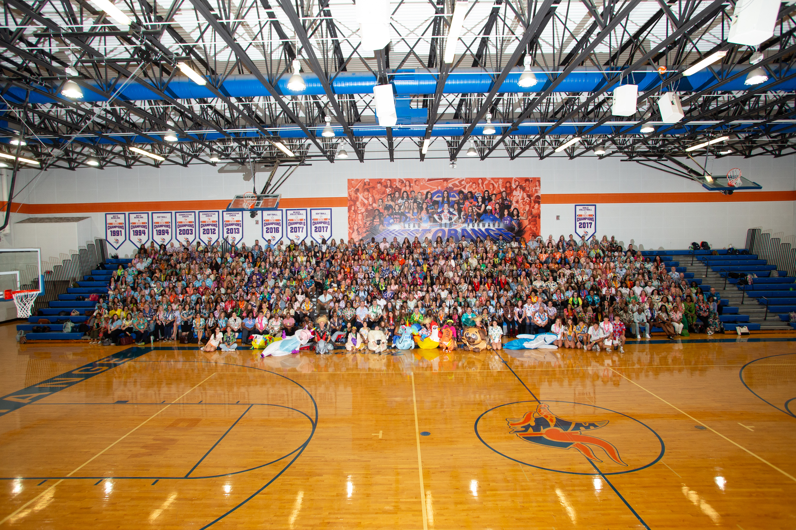 Large group photo of all ILI participants in gym bleechers