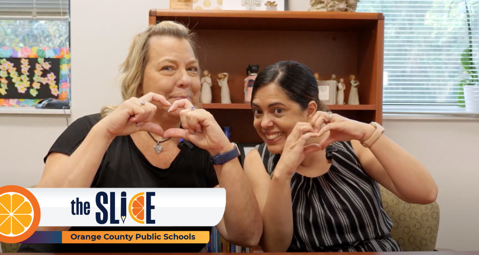 Two people make heart shape with fingers