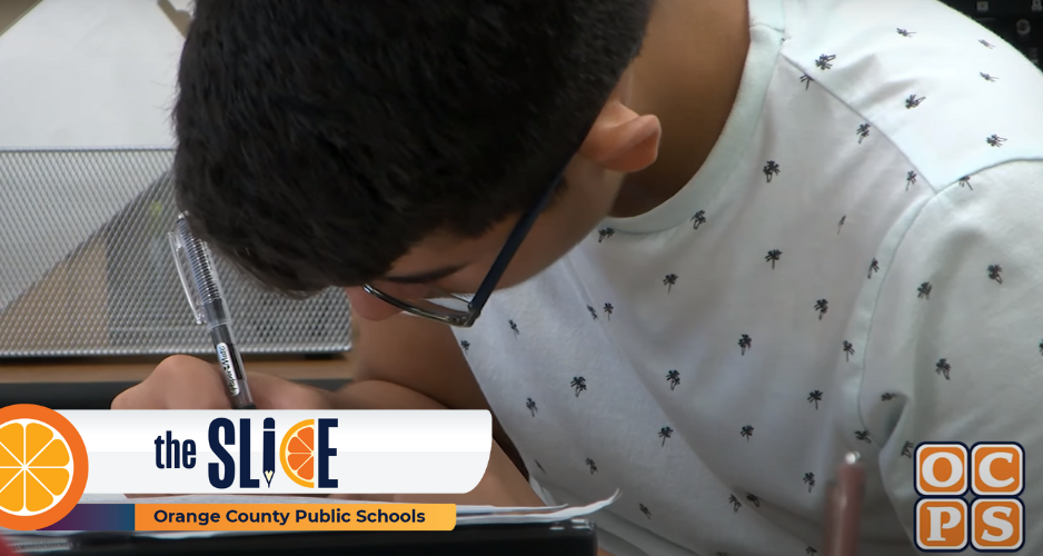 male student writes on paper