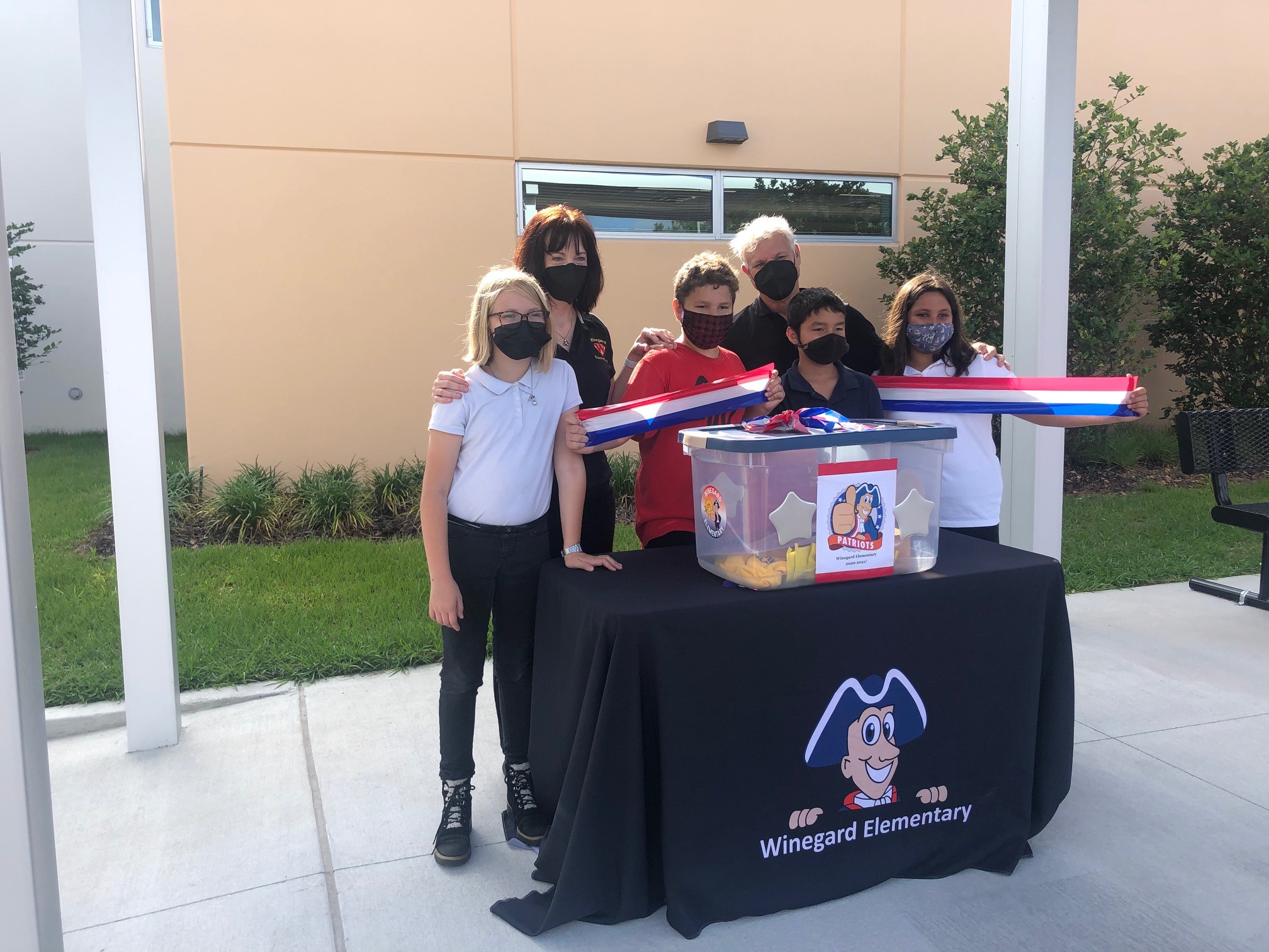 6 people stand at Winegard ES table