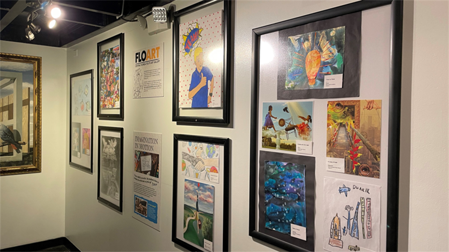 Photo of student artwork framed on a gallery wall