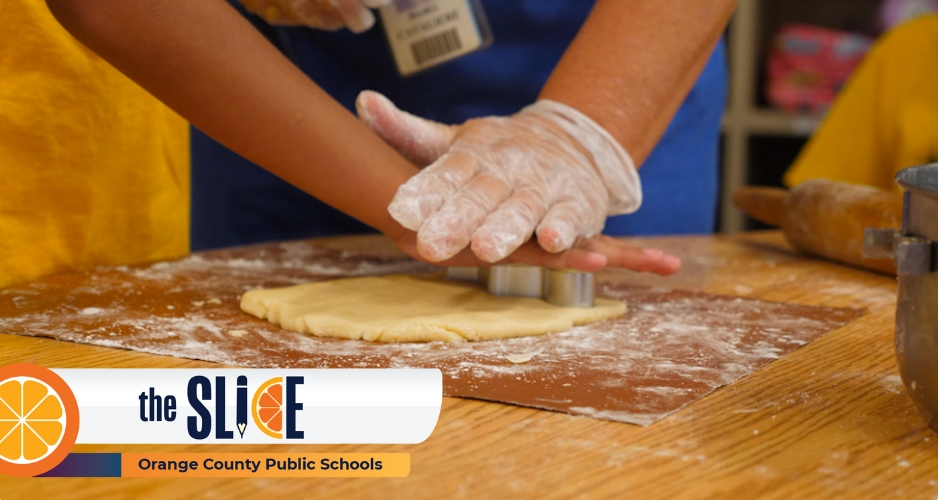 Isabel Cavaliere Enriquez helps her students press cookie molds into sugar cookie dough