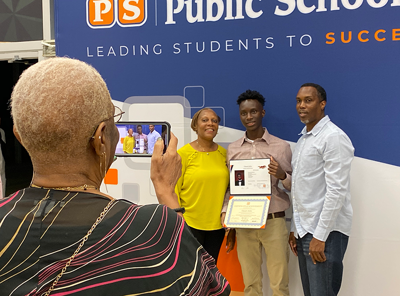 Family poses in front of OCPS backdrop