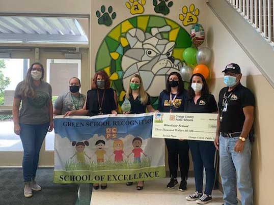 Blankner Green team holds a check