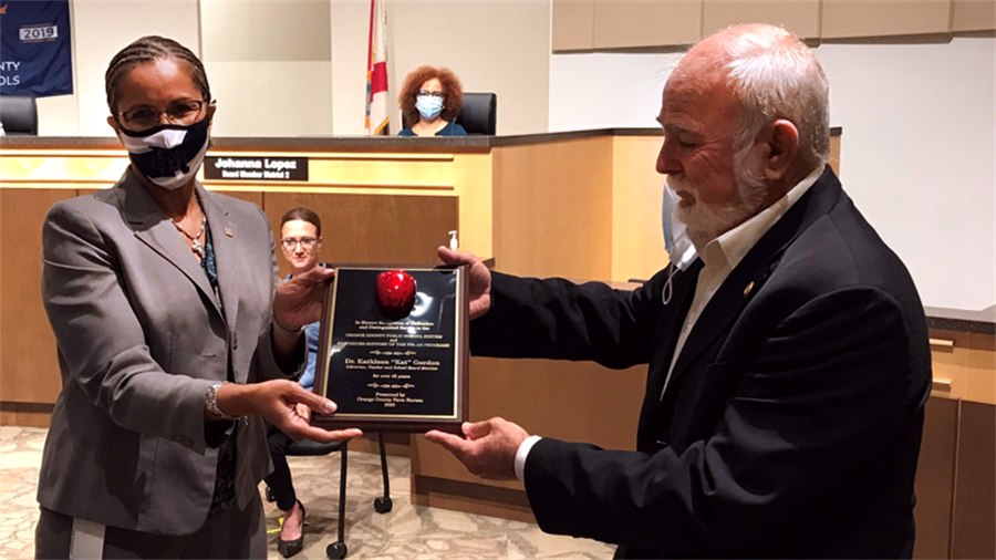 Superintendent Jenkins receives plaque from Bobby Beagles