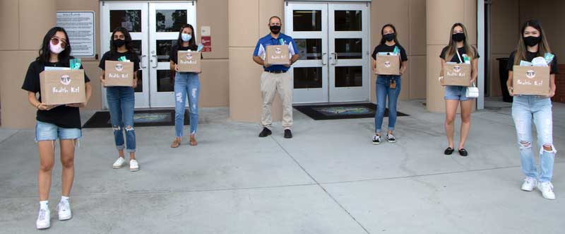 7 people hold MaskON boxes