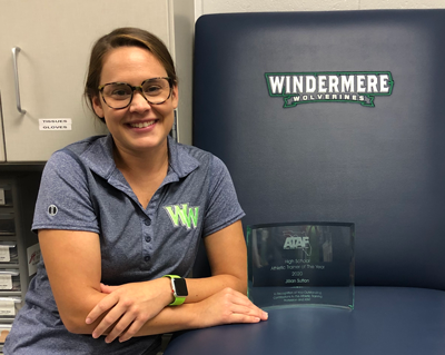 Jillian Sutton smiles with the glass award