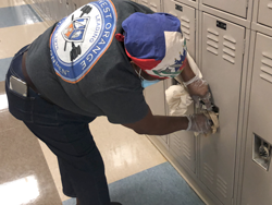 Custodian cleans a locker