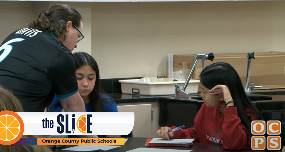 Teacher helping two students