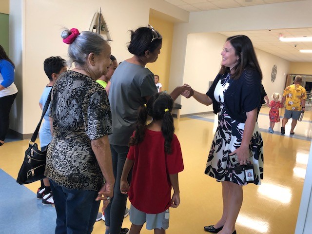 Principal greeting guests