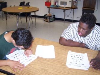 Two Students Working at a Table Two Students Working at a Table
