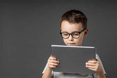 Boy holding an iPad.