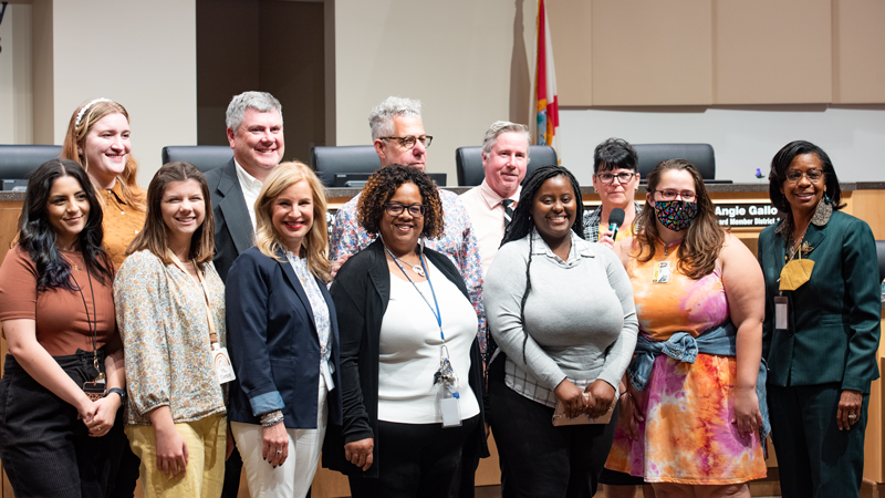 A group of people smile for the camera