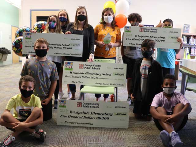 Westpointe green team with checks