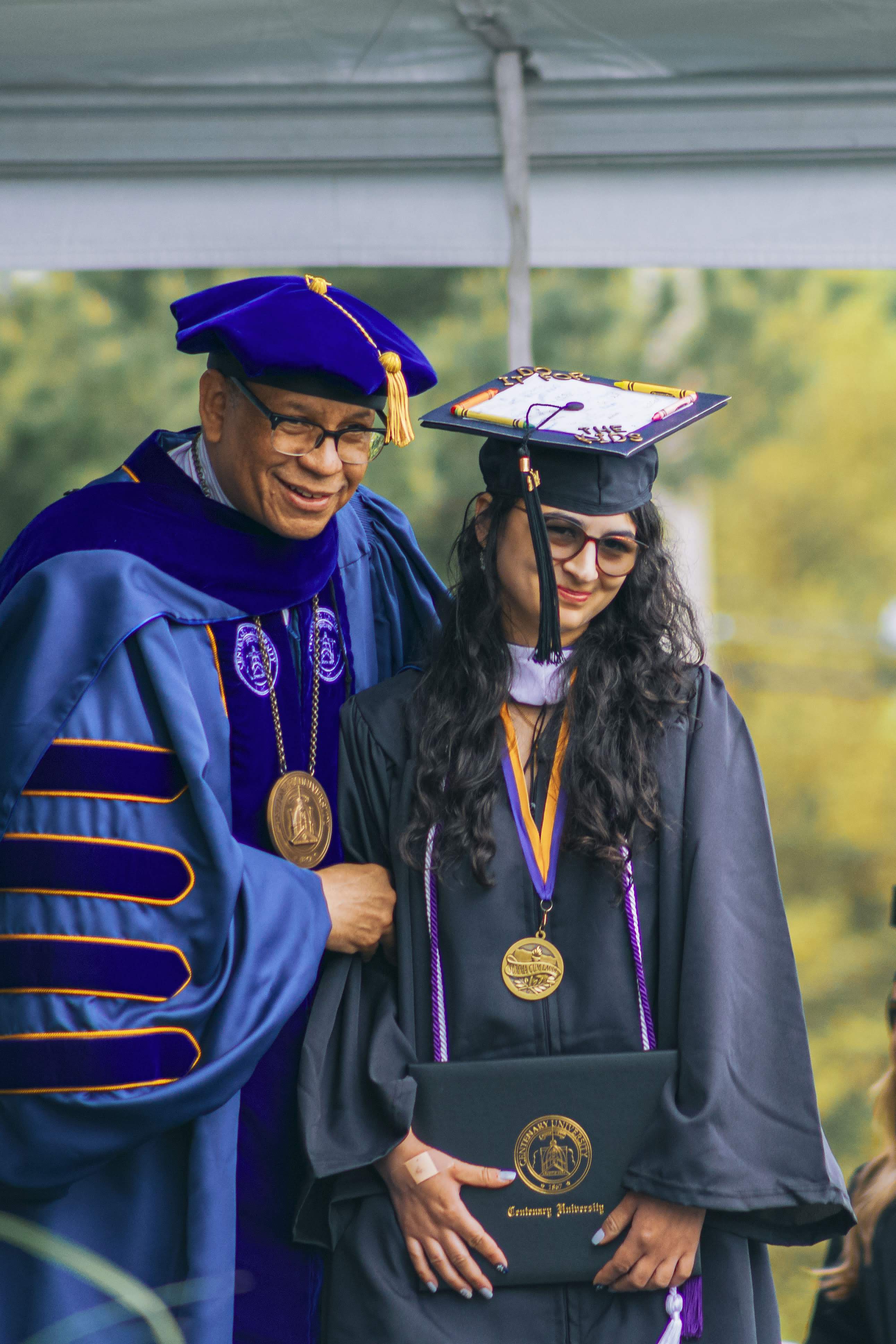 Miss Dutta posing at Centenary University's graduation with President Dale Caldwell.