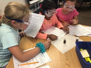 4th graders investigate an oil spill project.