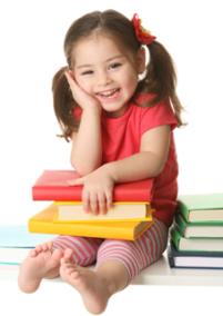 Smiling girl holding books on lap