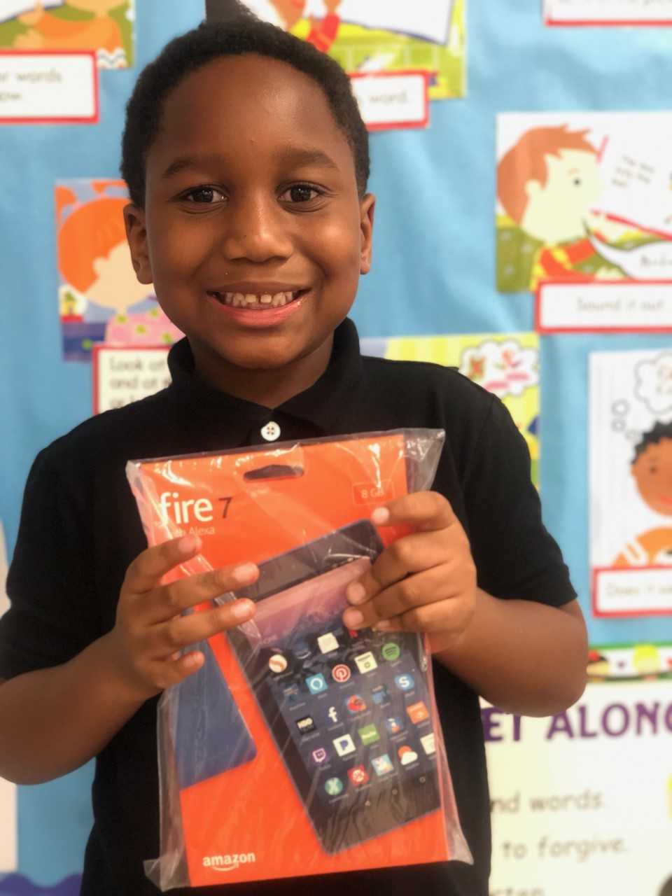 Izaiah holding Kindle