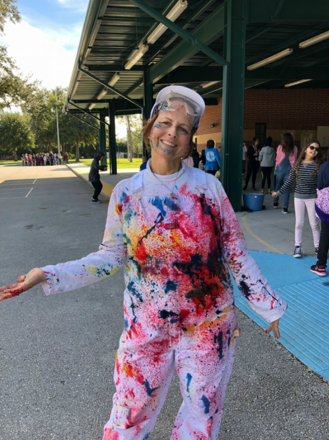 Mrs. Eastham covered with paint after being painted by students