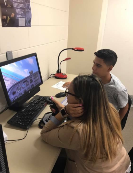 Students using flight simulator on computer Students using flight simulator on computer