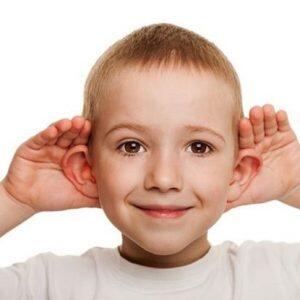 Young boy with hands behind his ears 