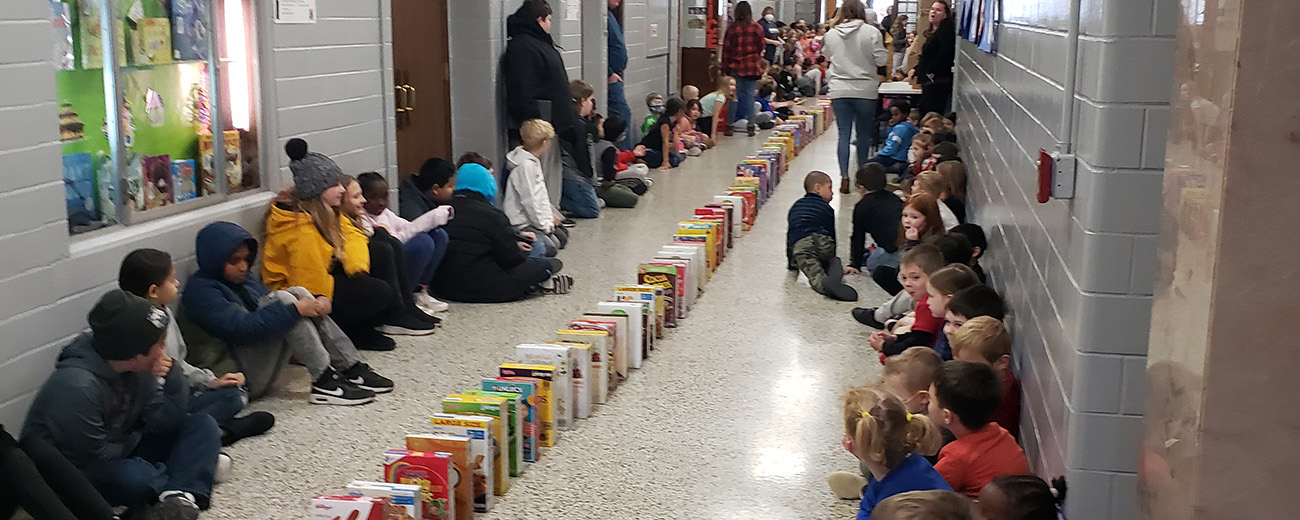 cereal boxes line the hallways with students looking on