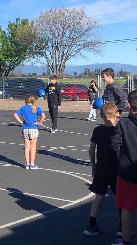 Students teaching basketball skills