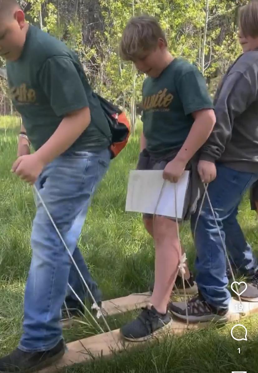 Students using a board to walk