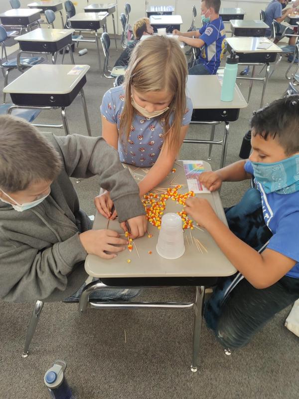 Students making a candy corn tower