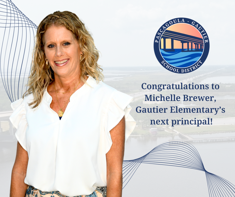 Michelle Brewer smiles in front of drone image over pascagoula