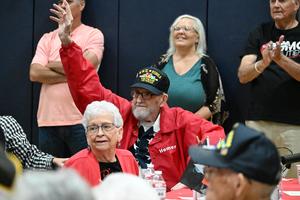 97-year-old veterans waves to crowd while attending veteran day breakfast