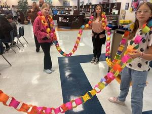 Gautier Middle School students hold 'Hope Chain' out as they connect the paper links