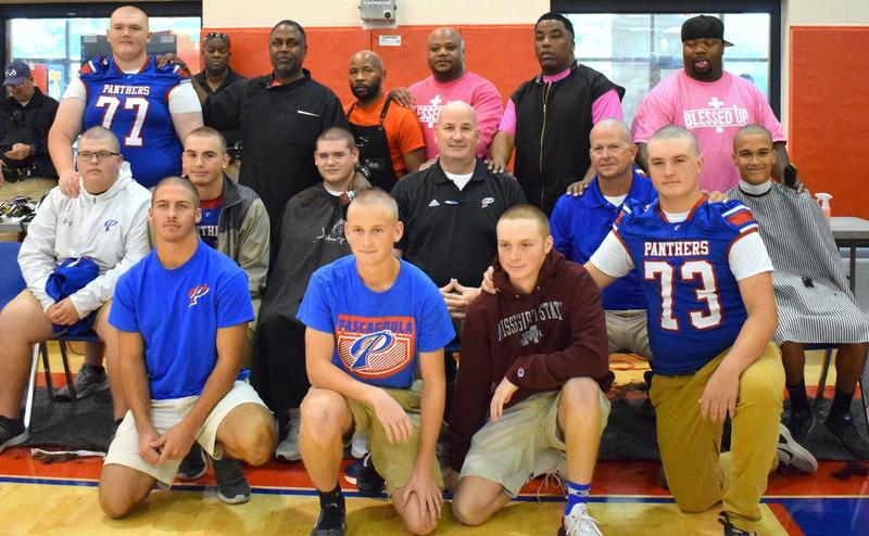 Students and staff with shaved heads