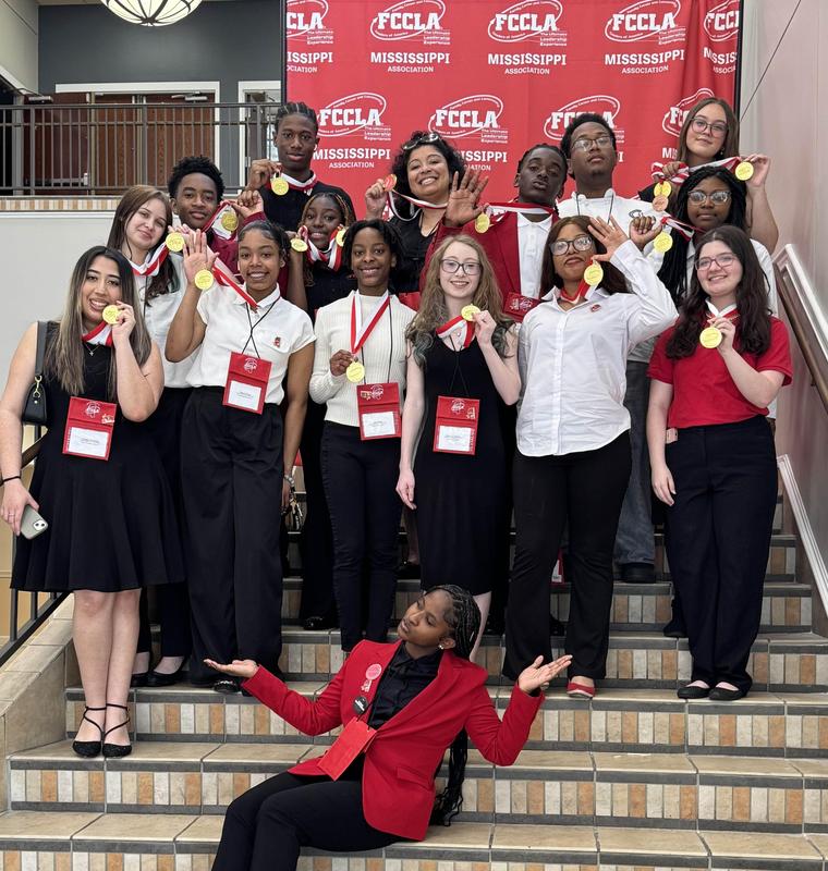 GHS FCCLA team poses with their gold medals together in a stairwell