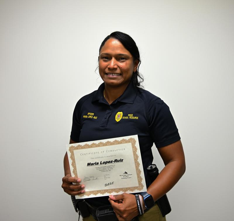 Officer Maria Lopez holds her DARE certificate