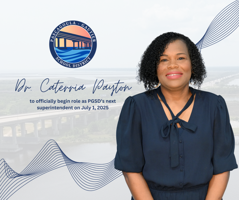 Dr. Caterria Payton smiles in front of a background of a drone shot of the Pascagoula River and bridge