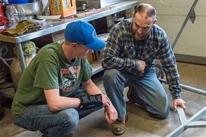 Isaac Habermehl shows a student a weld 