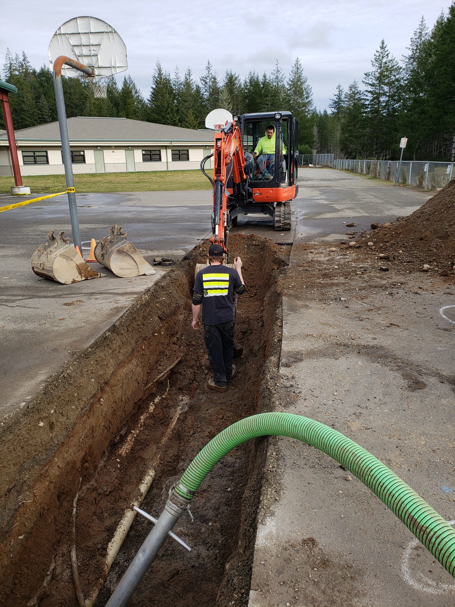 Backhoe digs up area around the Pioneer Elementary water main